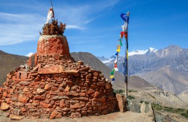 Tibetan Stupa with flags along the Annapunra Circuit Trek, Nepal
